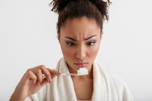 Woman Looking at Toothpaste