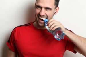 Man Opens Bottle of Water using Teeth